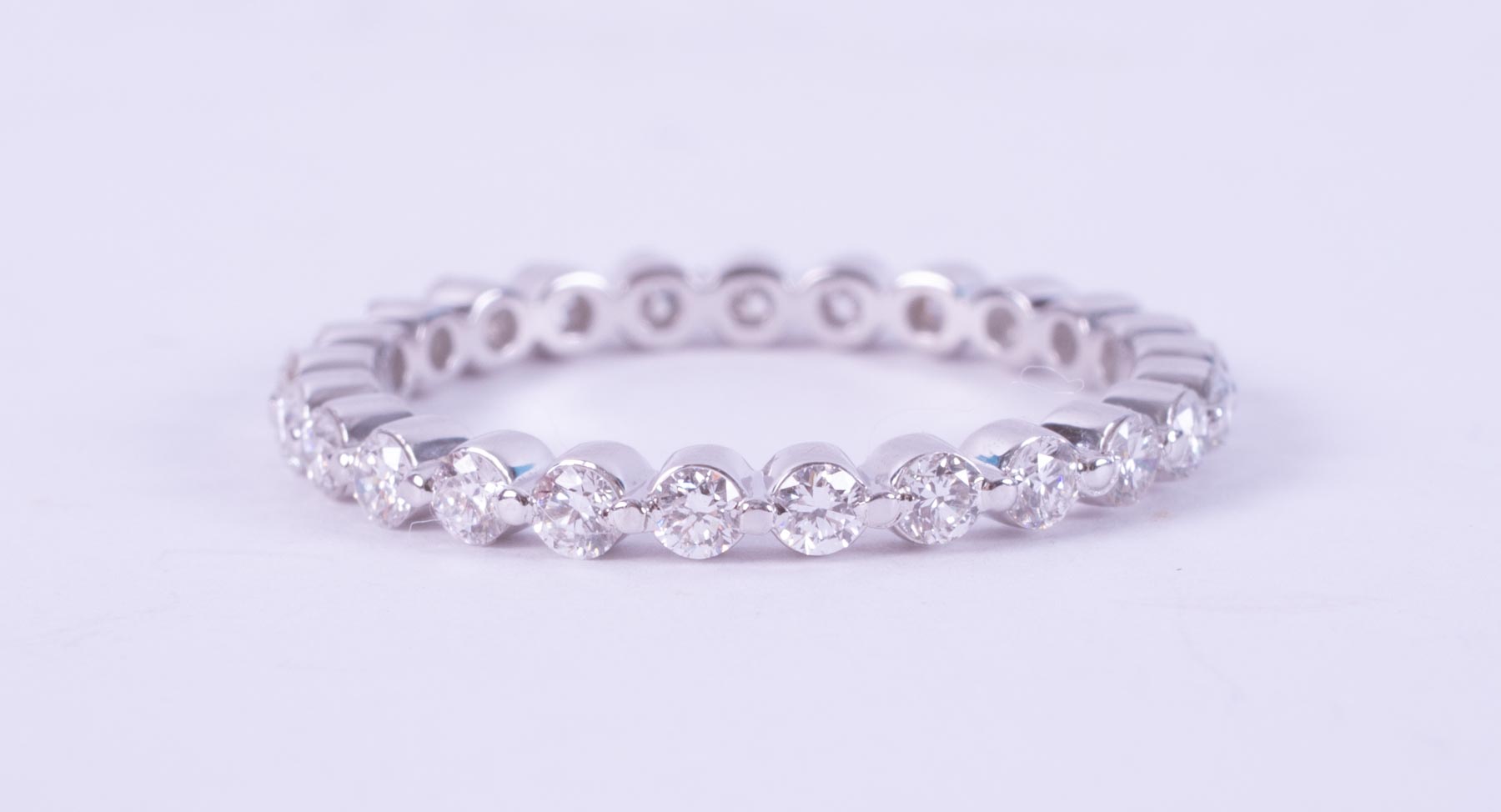 A 14ct white gold full eternity set with 0.90 carats total weight of round brilliant cut