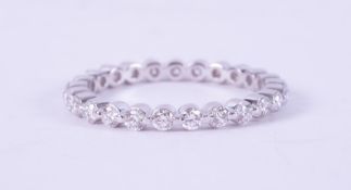 A 14ct white gold full eternity set with 0.90 carats total weight of round brilliant cut