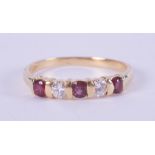 An 18ct yellow gold band set with three round cut rubies, total weight approx. 0.30 carats