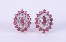 A pair of 9ct yellow gold oval shaped cluster earrings set with round cut rubies and round cut