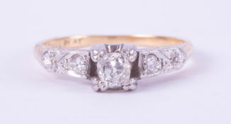 An 18ct yellow gold & platinum ring set with a central cushion shaped diamond, approx. 0.38 carats