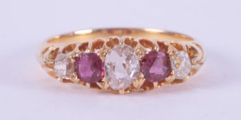 An antique 18ct yellow gold five stone ring set with three old cut diamonds, the central diamond