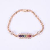 An 18ct yellow gold chain link bracelet set centrally with seven square cut gemstones to include