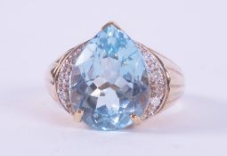 A 9ct yellow gold ring set centrally with a pear shaped blue topaz, approx. 9.00 carats, with