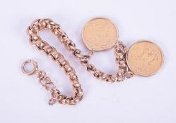 A 9ct yellow gold curb link bracelet with two mounted full sovereigns, one dated 1958