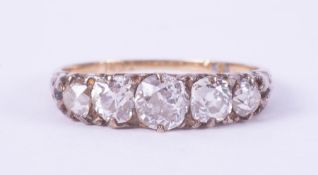 An antique 18ct yellow gold five stone ring set with slightly off round cut diamonds, total weight
