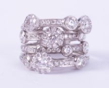 A white gold (not hallmarked or tested) multi-row ring set with round brilliant cut diamonds,