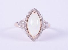 A 9ct yellow gold ring set with a marquise cabochon cut white opal, measuring approx. 15mm x 12mm,