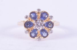 An 18ct yellow gold flower design ring set with six oval cut sapphires, total weight approx. 0.90