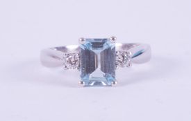 An 18ct white gold ring set with an emerald cut aquamarine, approx. 1.65 carats, set either side