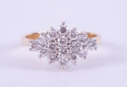 An 18ct yellow & white gold marquise shaped ring set with round brilliant cut diamonds, total