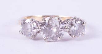 An 18ct yellow gold & platinum three stone ring set with older round cut diamonds, total weight