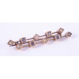 An antique yellow gold (not hallmarked or tested) bar brooch in a geometric style set with