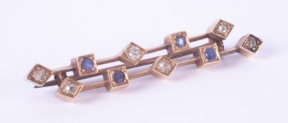 An antique yellow gold (not hallmarked or tested) bar brooch in a geometric style set with