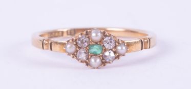 An antique 18ct yellow gold ring set with a central emerald cut emerald, surrounded by four small