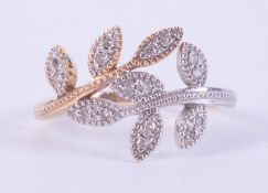 A 9ct yellow & white gold leaf design ring set with small round brilliant cut diamonds, total