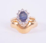A set comprising of an 18ct yellow & white gold cluster design ring set with a central blue