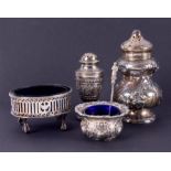 A Victorian silver pepper pot, a silver table salt and another with blue glass liners and a silver