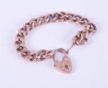 A 9ct rose gold curb link bracelet with flower engraved heart padlock, and pattern engraved links,