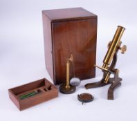 A vintage brass table microscope with original box.