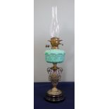 A Victorian oil lamp with turquoise reservoir with brass and ceramic base, height excluding