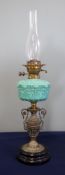 A Victorian oil lamp with turquoise reservoir with brass and ceramic base, height excluding