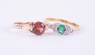 An antique 18ct yellow gold & platinum ring set with a central emerald cut emerald, approx. 0.25