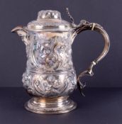 A George III silver lidded flagon/jug with spout, face mask decoration, embossed with flowers,