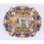 An antique polychrome Majolica plate, diameter 25cm, (the image is based on a marble bas relief by