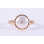 A yellow gold ring (not hallmarked or tested) set with a circular maybe pearl, 9mm diameter & set