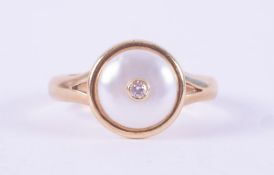 A yellow gold ring (not hallmarked or tested) set with a circular maybe pearl, 9mm diameter & set