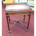 A mahogany reproduction occasional table, with pierced fretwork gallery and cluster column legs,