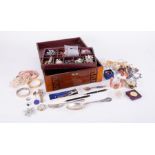 A wooden vintage jewellery box with costume jewellery to include brooches, pendants, chains,