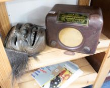 A Bush Bakelite dac 90 radio and a African face mask, carved wood.