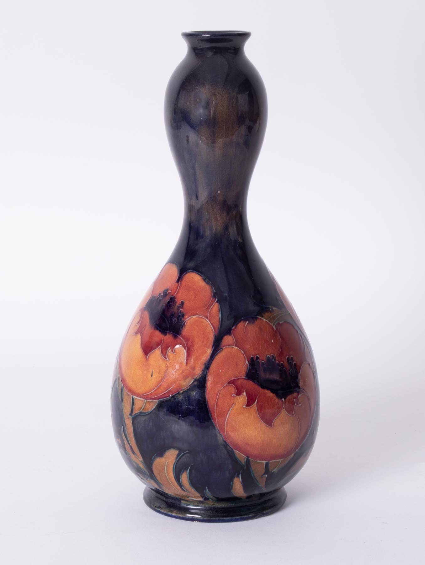 A William Moorcroft Gourd shaped vase, decorated with 'Poppy', circa 1923, height 32cm.