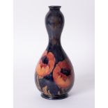 A William Moorcroft Gourd shaped vase, decorated with 'Poppy', circa 1923, height 32cm.