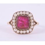 An antique Georgian 9ct yellow gold ring set with a square cut bright pink paste stone measuring