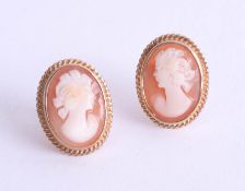 A pair of 9ct gold oval cameo earrings, each with 14mm x 10mm hand carved Italian shell, with yellow