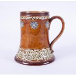 A Doulton Lambeth Art pottery tankard decorated with flowers, height 15cm.