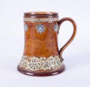 A Doulton Lambeth Art pottery tankard decorated with flowers, height 15cm.