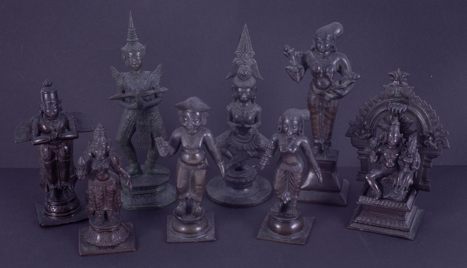 Eight bronze deity figures, tallest 20cm.