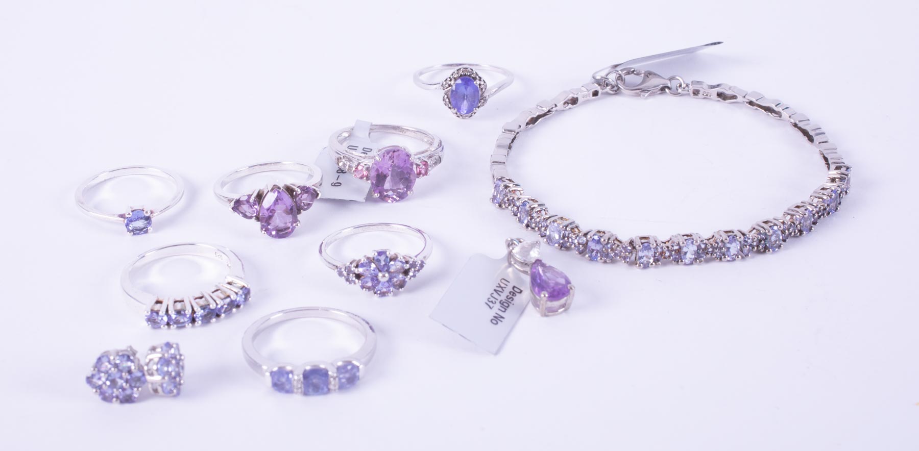 A mixed lot of silver jewellery to include five tanzanite set rings, a tanzanite set bracelet & a