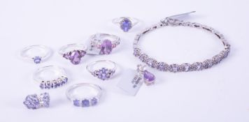 A mixed lot of silver jewellery to include five tanzanite set rings, a tanzanite set bracelet & a
