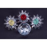 Swarovski Crystal Glass, red, yellow and green daisy and SCS crystal paperweight ball, boxed (4).