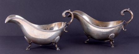 A pair of Geo. V gravy boats, with scroll handles, hoof feet and gadrooned edging, with