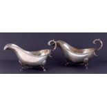 A pair of Geo. V gravy boats, with scroll handles, hoof feet and gadrooned edging, with