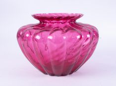 A large cranberry coloured squat glass vase, height 18cm.