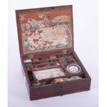 A mahogany cased artist's box fitted with multi coloured chalk/paint blocks, with paper label to the