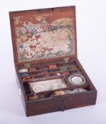 A mahogany cased artist's box fitted with multi coloured chalk/paint blocks, with paper label to the