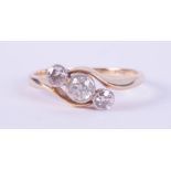 An 18ct yellow gold three stone twist style ring set with round brilliant cut diamonds, total